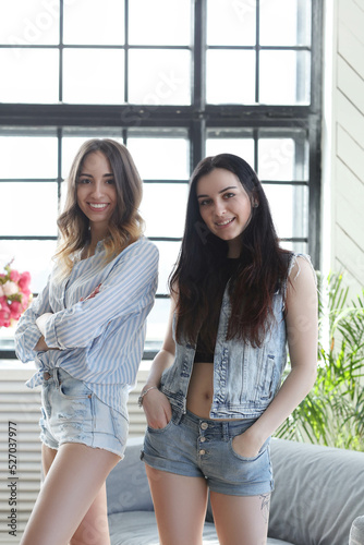 Sisterhood is on full display in this heartwarming stock photo, capturing the pure joy and unbreakable bond shared between best friends forever during a playful photo shoot at home