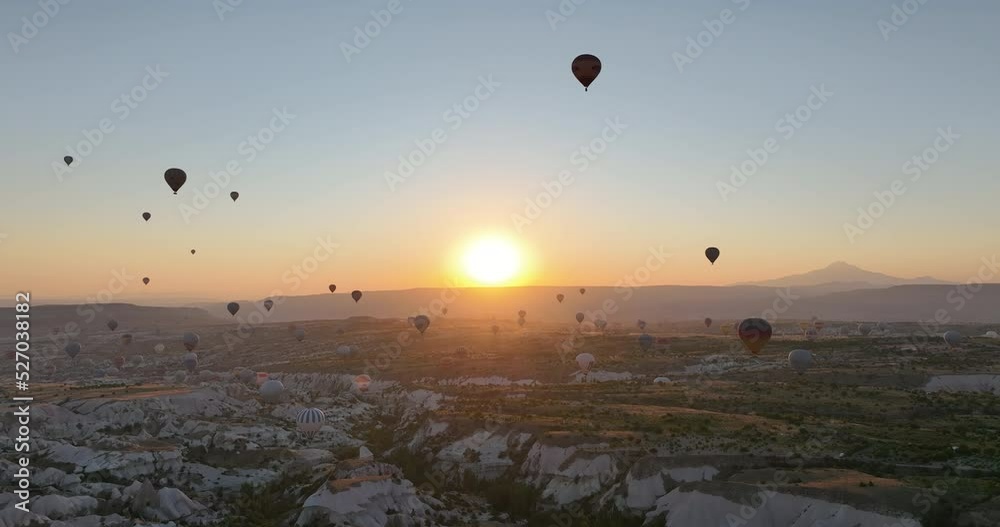 Aerial cinematic drone view of colorful hot air balloon flying over Cappadocia Aerial cinematic drone view of colorful hot air balloon flying over Cappadocia