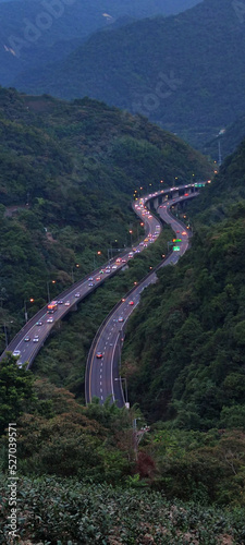 curved highway through the green rice fields with houses scattered throughout the plain in Yilan, Taiwan ~ Aerial view of National Freeway No.5, Taipei-Ilan Section in Ilan, Taiwan, Asia