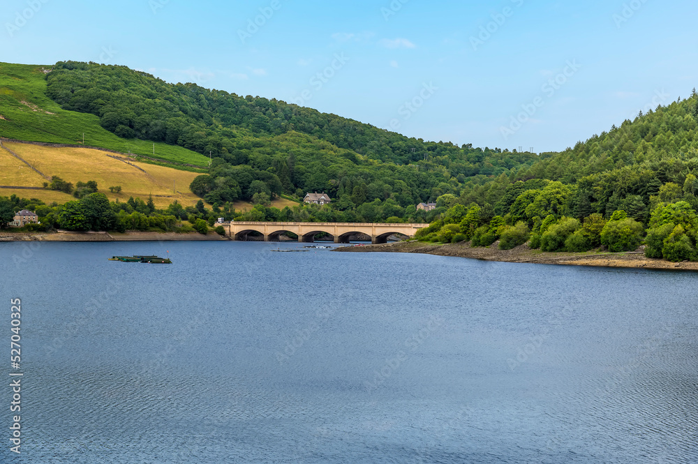 A view from the dam wall towards the bridge over Ladybower reservoir, Derbyshire, UK in summertime
