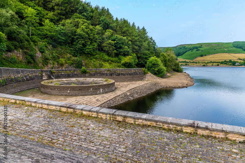 A view from the dam wall towards the overflow plughole on the west shore of Ladybower reservoir, Derbyshire, UK in summertime