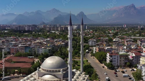White Mosque, Cityscape and Mountains. Antalya, Turkey. Aerial View. Drone Flies Backwards and Upwards photo