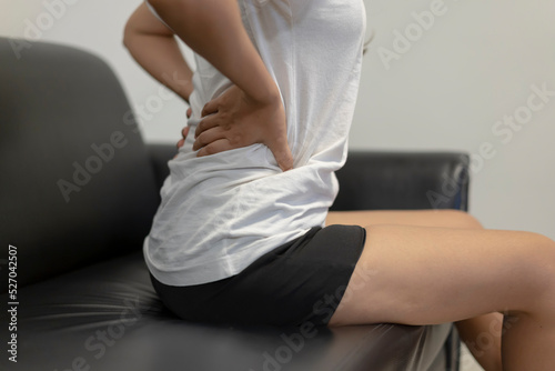 Asian woman suffering from backache and Office syndrome and Healthy Concept.