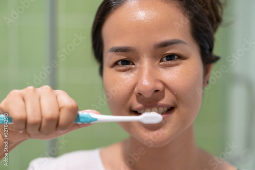 Asia woman brushing her teeth.