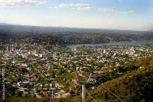 
Landscape of the city of Villa Carlos Paz, Cordoba, Argentina. Tourist city of the Valley of Punilla. Latin America. Tourist attraction. View from the Aerosilla hill. Mountains, lakes. Chairlift.