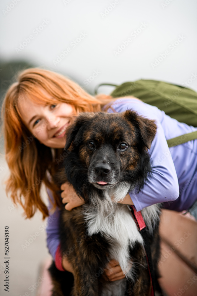 portrait of happy smiling woman who hugs her shaggy dog portrait of happy smiling woman who hugs her shaggy dog