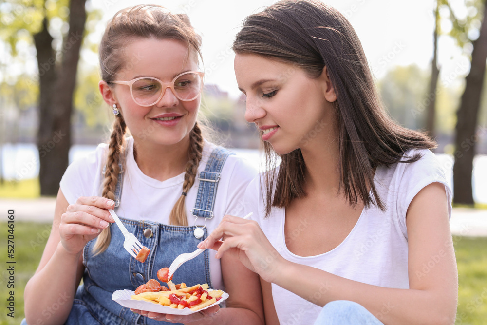 Nature's Beauty: Women Having a Relaxing Picnic in the Park Nature's Beauty: Women Having a Relaxing Picnic in the Park