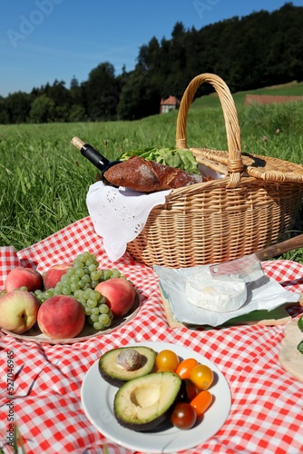 A picnic is nature, friends and deliciousness (fried sausages, potatoes and ripe tomatoes, cucumbers, avocados and cold wine)