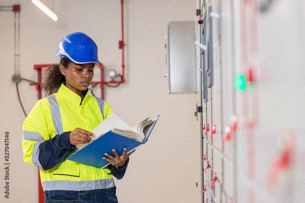 Electrical engineer working in control room. Electrical engineer man