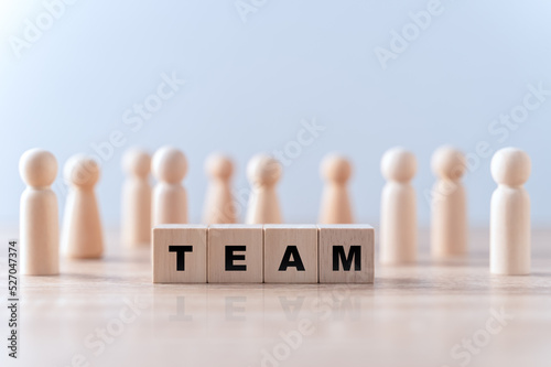 Word team on wooden block, relationship of collaboration and leadership for success, group of community and employee with corporate, teamwork for brainstorming together, no people, business concepts.