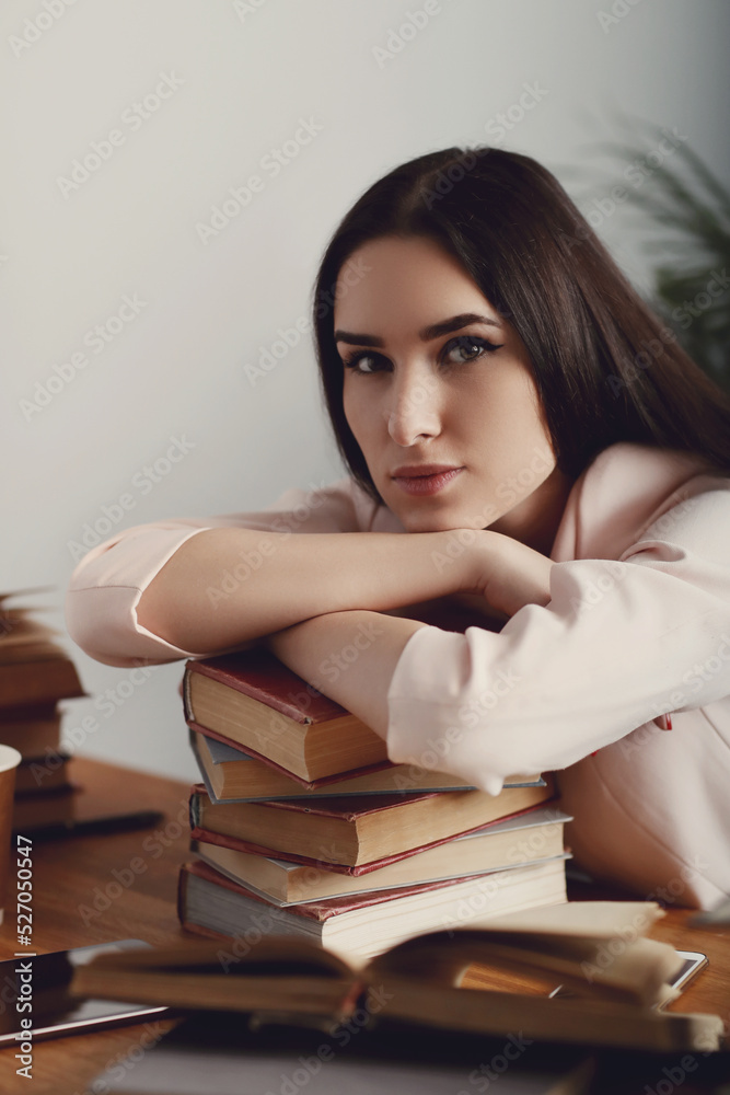 This book-loving brunette strikes a pose of intellect and poise as she indulges in a literary adventure at the library, capturing the perfect shot for educational publications, lifestyle blogs
