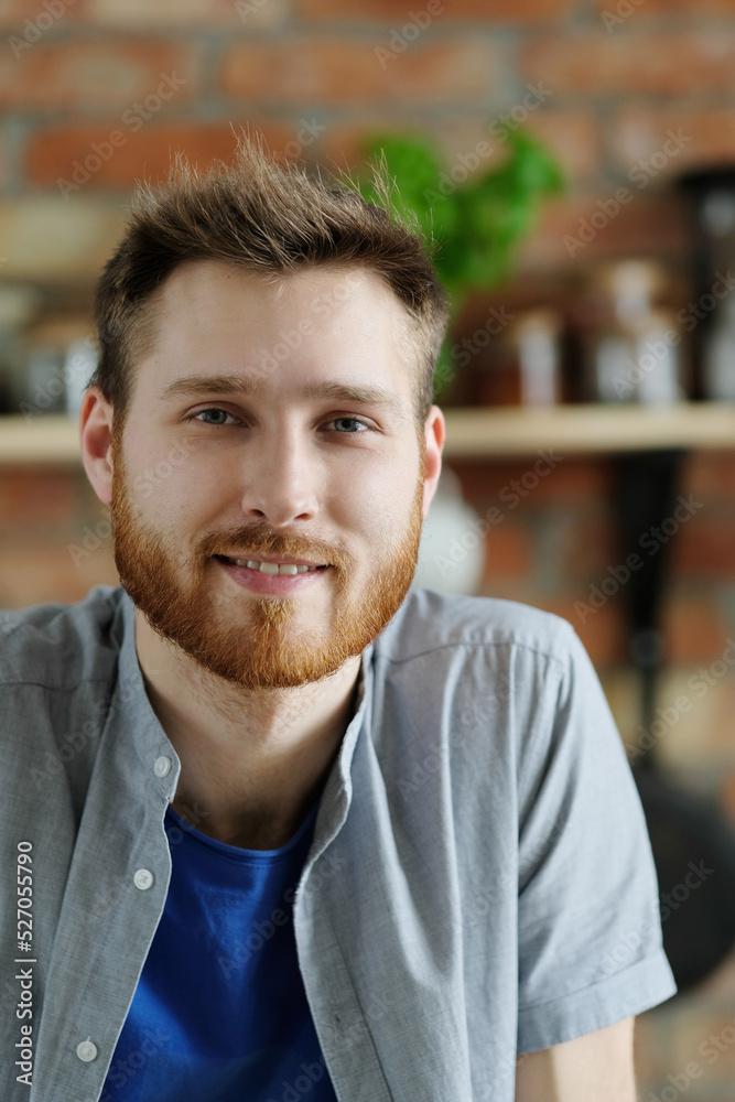 Handsome young man with beard posing on the kitchen Handsome young man with beard posing on the kitchen