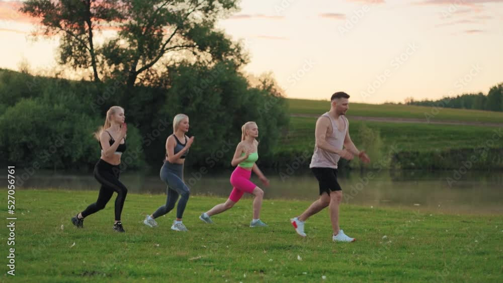 athletic male coach is teaching group of beautiful slender women physical exercise for legs and buttocks athletic male coach is teaching group of beautiful slender women physical exercise for legs and buttocks