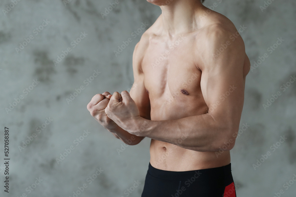 Obraz premium Handsome Young Middle Eastern Male Athlete Warming Up Before Training At Gym, Preparing For Fitness Workout In modern Sport Club, Copy Space