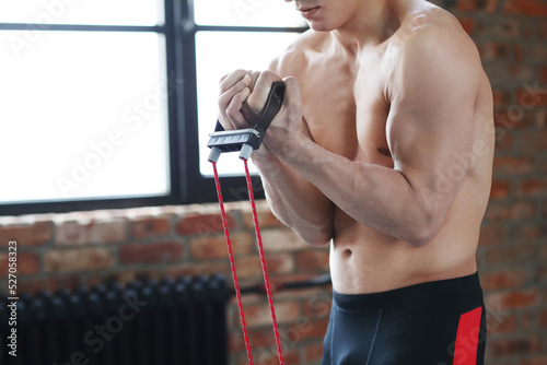Handsome Young Middle Eastern Male Athlete Warming Up Before Training At Gym, Preparing For Fitness Workout In modern Sport Club, Copy Space