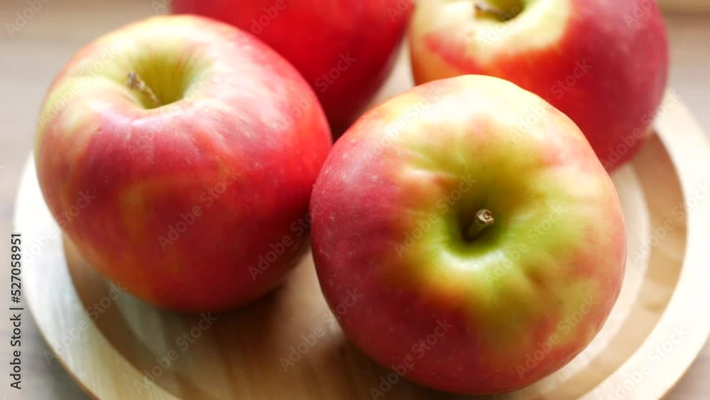 Close up of fresh apple in a bowl on wooden table Close up of fresh apple in a bowl on wooden table