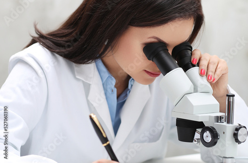 a woman in a lab coat looking through a microscope, portrait of a female pathologist, microscopy, under a microscope, in laboratory, sitting on a lab table, in a laboratory