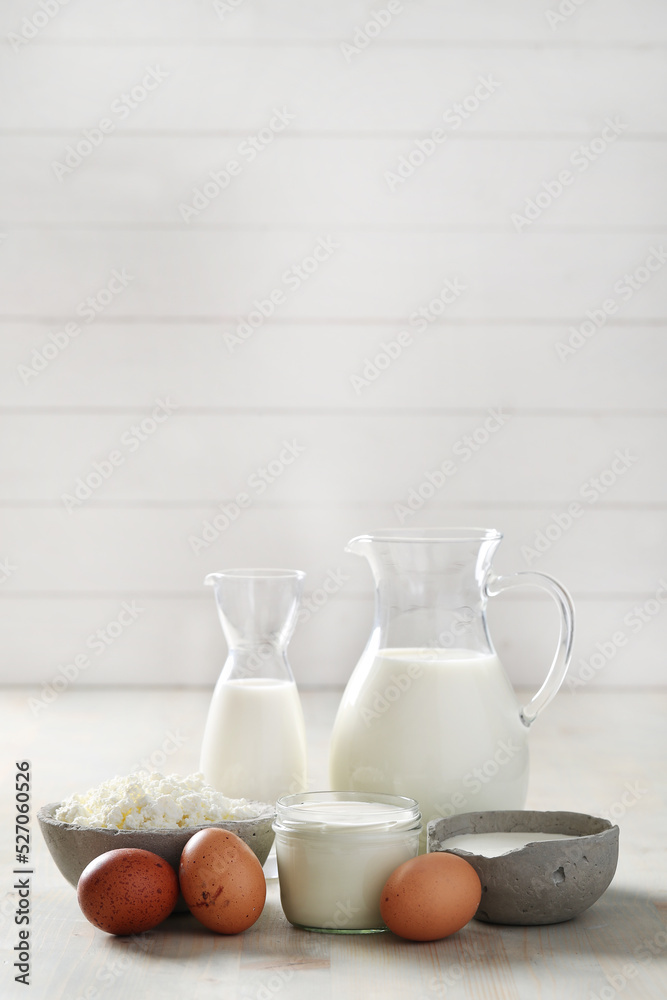 Homemade cooked healthy milk products for breakfast in a wooden bowl on the table and near a bottle of milk. Place for text. Fitness food, snack Homemade cooked healthy milk products for breakfast in a wooden bowl on the table and near a bottle of milk. Place for text. Fitness food, snack