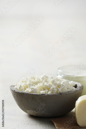 Homemade cooked healthy milk products for breakfast in a wooden bowl on the table and near a bottle of milk. Place for text. Fitness food, snack