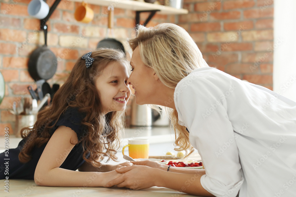 Mother and Daughter Enjoying Breakfast Together on a Sunny Morning Mother and Daughter Enjoying Breakfast Together on a Sunny Morning