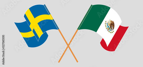 Crossed and waving flags of Sweden and Mexico