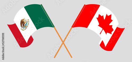 Crossed and waving flags of Mexico and Canada