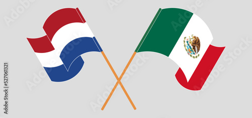 Crossed and waving flags of the Netherlands and Mexico