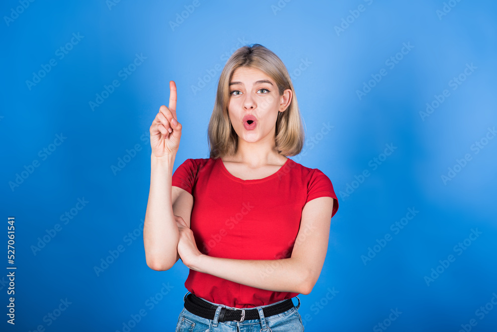 Fototapeta premium Young and attractive caucasian blonde girl in casual clothes with open mouth showing idea gesture isolated on blue studio background.