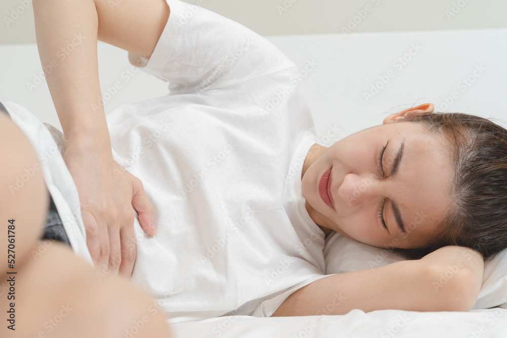 person feeling stomach pain menstruation on the bed. person feeling stomach pain menstruation on the bed.