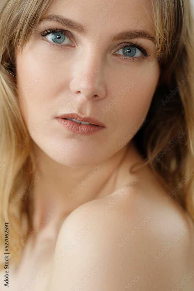 Close view of young blond woman looks at camera and pose at home Close view of young blond woman looks at camera and pose at home