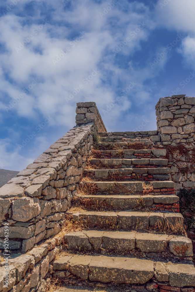 Day view of empty stone old staircase steps without people, against blue sky with clouds. Day view of empty stone old staircase steps without people, against blue sky with clouds.