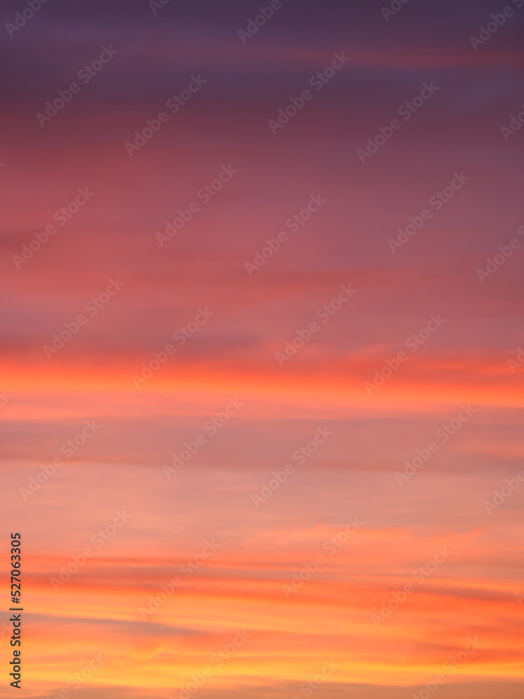 vibrant colorful background of red pink purple orange clouds in sunset sky, blurry dawn sky full frame texture