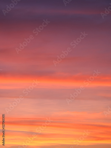 vibrant colorful background of red pink purple orange clouds in sunset sky, blurry dawn sky full frame texture © Oleksii