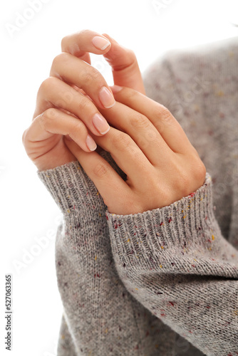 Beautiful women’s hands with groomed nails on a light background