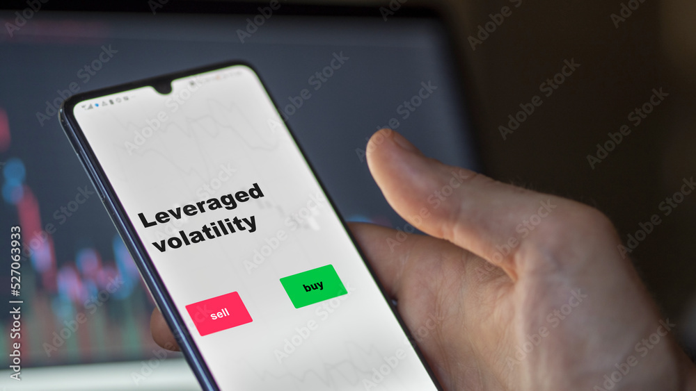 An investor's analyzing the leveraged volatility etf fund on screen. A phone shows the ETF's prices leverage to invest An investor's analyzing the leveraged volatility etf fund on screen. A phone shows the ETF's prices leverage to invest