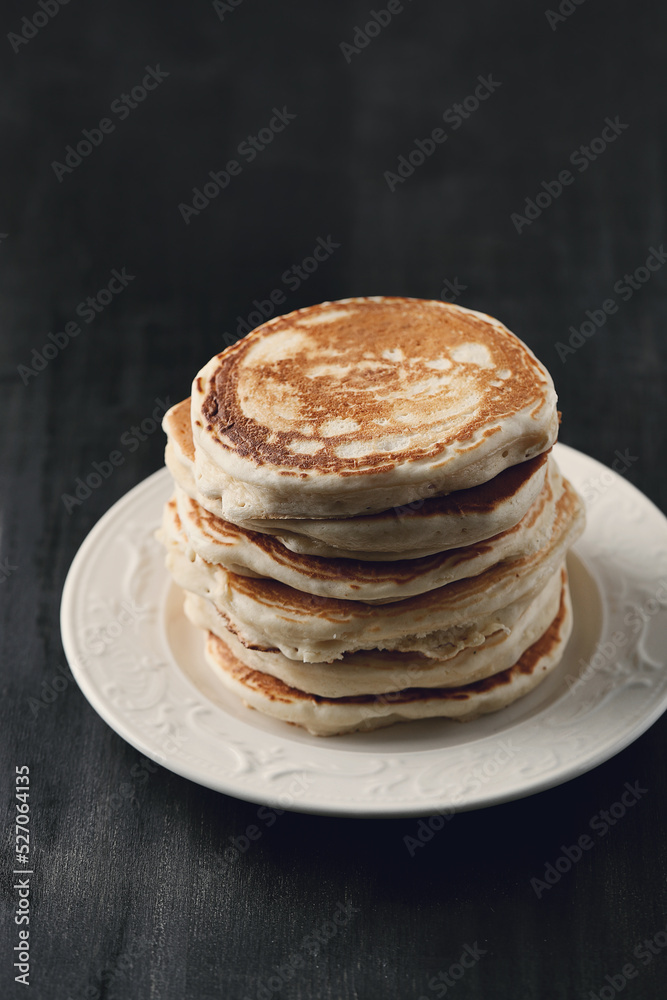 Healthy summer breakfast with classic pancakes with a slice of melted butter in the plate Healthy summer breakfast with classic pancakes with a slice of melted butter in the plate