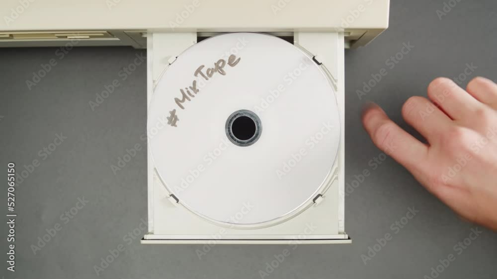 Using CD circle disk close-up. Old dvd player, disc drive top view. Music recorder, playing retro computer games. 