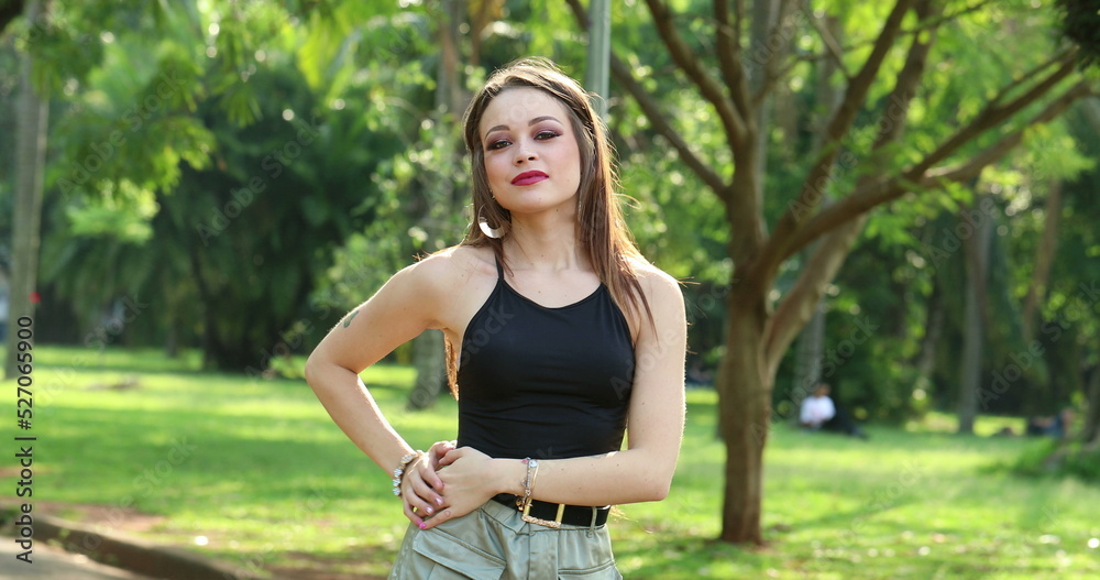 Pretty girl feeling relaxed posing in outdoor park Pretty girl feeling relaxed posing in outdoor park