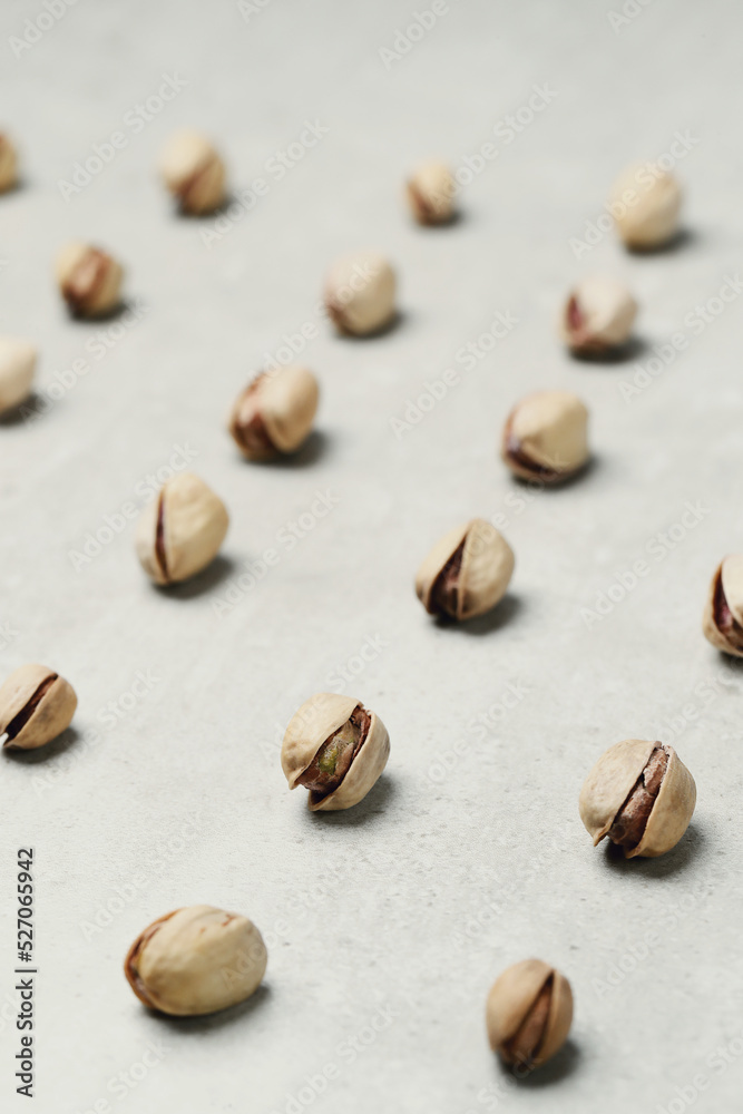A number of delicious pistachios on a light background