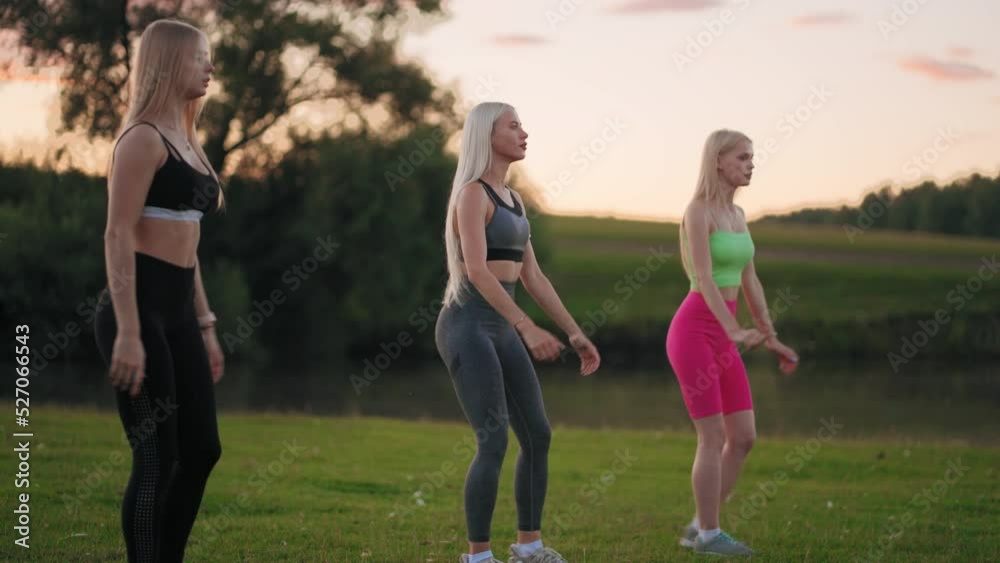 alluring blonde athletic ladies are squatting for beautiful booty shape and slender hips, group fitness class alluring blonde athletic ladies are squatting for beautiful booty shape and slender hips, group fitness class