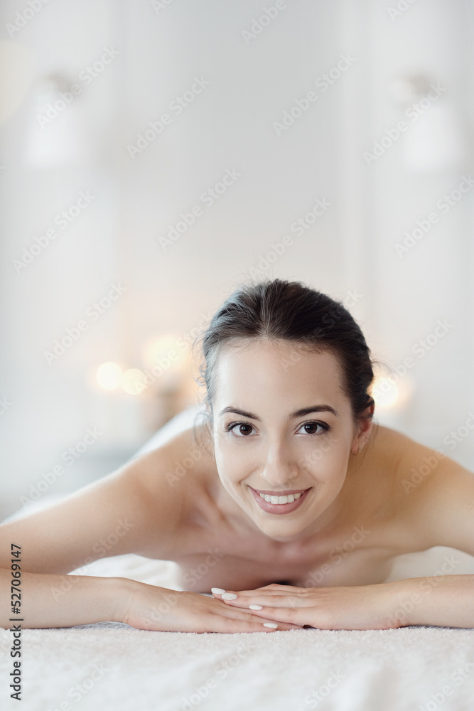 Relaxed beautiful young girl lying on the couch after massage in the spa Relaxed beautiful young girl lying on the couch after massage in the spa