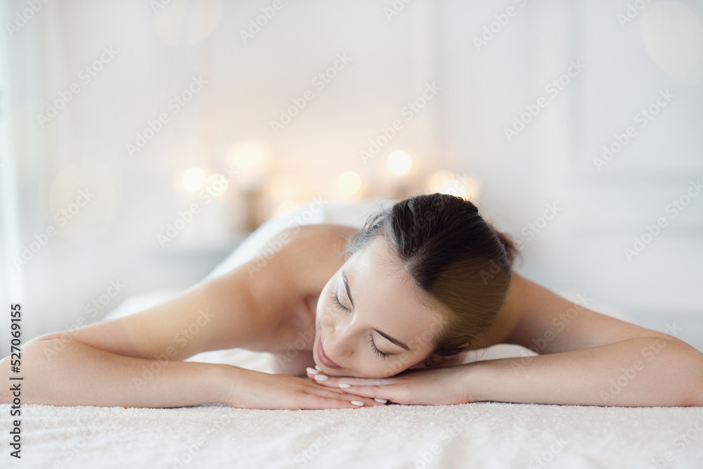 Relaxed beautiful young woman lying on the couch after massage in the spa Relaxed beautiful young woman lying on the couch after massage in the spa