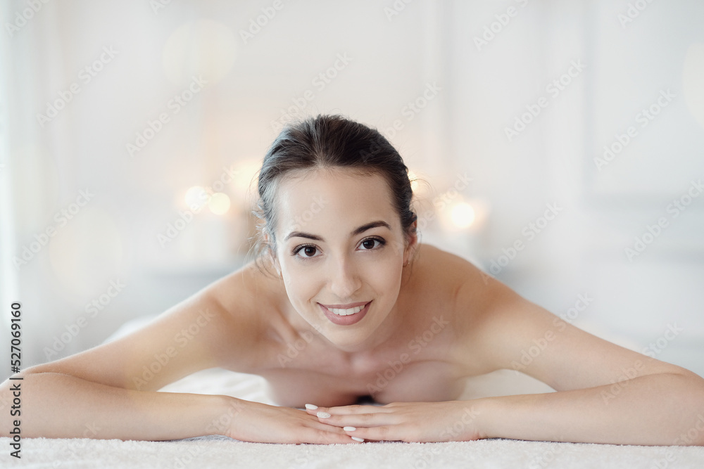 Relaxed beautiful young woman lying on the couch after massage in the spa Relaxed beautiful young woman lying on the couch after massage in the spa