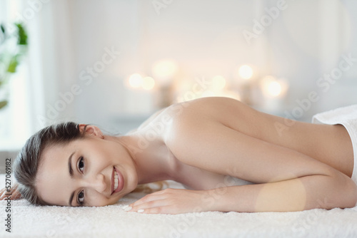 Relaxed beautiful young woman lying on the couch after massage in the spa