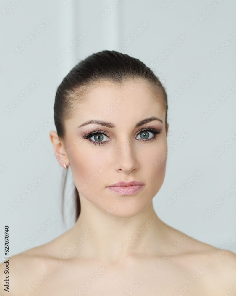 Glamorous portrait of a beautiful woman model with fresh daily makeup and tail-gathered hair