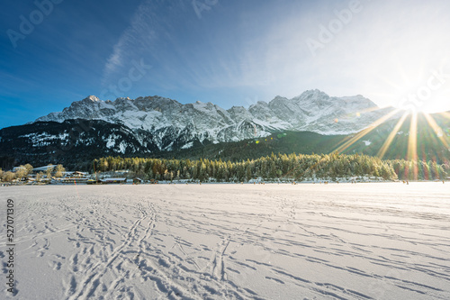 winter landscape with snow covered Zugspitze from frozen lake eibsee