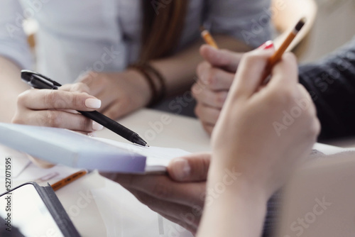 Business people using papers and pens at the meeting