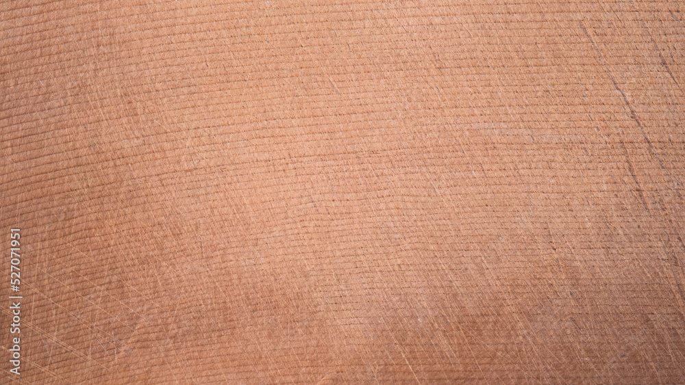 Fototapeta premium top view of brown hardwood cutting board for kitchen accessories. There are scratches from use. Natural Wood texture Background, Surface of teak, Wooden Desk Texture.