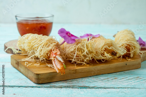 Fried shrimp in dough on wooden boards, close-up.