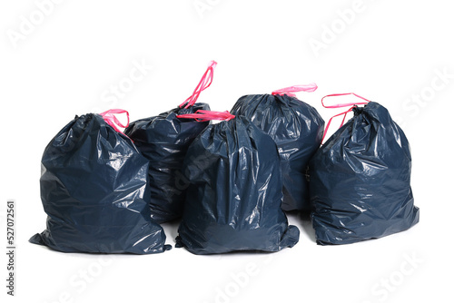 Many big black plastic bags for trash waste placed on a white background